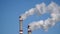 Industrial chimneys emits toxic pollutants into the sky polluting the environment