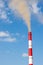 Industrial chimneys smoke smog on blue sky. Air pollution disaster concept. Day of the Planet Earth. Vertical frame