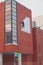 Industrial climber dismantling white banner from red brick wall