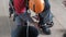 Industrial climber puts on equipment for high-altitude work. on the climber s belt carabiners.