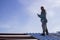 An industrial climber worker, insured on a safety rope, performing a task of installing metal structures at a high altitude