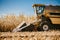 Industrial combine harvester working in the fields. Agriculture Farmer working with harvester machinery