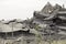 Industrial concrete building destructed by strike. Disaster scene full of debris, dust and crashed buildings