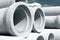 Industrial concrete drainage pipes stacked for construction. New tubes