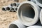Industrial concrete drainage pipes stacked for construction. New tubes