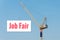 Industrial Construction crane holding a billboard with Job Fair