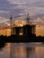 Industrial construction cranes and building silhouettes