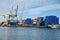 Industrial crane loading Containers in the port of Rotterdam.