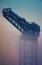 Industrial Crane At Sunrise In The Fog