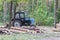 Industrial deforestation by forestry workers using machinery