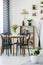 Industrial dining room interior with a table, black chairs, pink