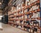 Industrial distribution, composition. Storage with high shelves, cargo boxes on racks. Rows of shelves with boxes at the factory