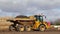 Industrial dumper truck moving earth on a construction site