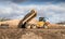 Industrial dumper truck moving tipping earth on a construction site