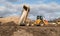 Industrial dumper truck moving tipping earth on a construction site