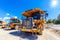 Industrial dumper trucks on construction site.