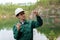 Industrial ecologist visually evaluates the response of a water sample from lake at the site of a flooded quarry