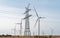 Industrial electricity tower for power supply in landscape amid a windfarm