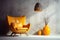 Industrial Elegance Grey Decorative Vase, Orange Pendant Light, Leather Wingback Chair, and Concrete Stucco