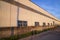 Industrial evening sunlight reflecting on the industrial warehouse against the blue sky landscape view