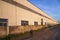 Industrial evening sunlight reflecting on the industrial warehouse against the blue sky landscape view