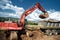 Industrial excavator loading soil material from quarry