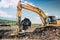 Industrial excavators and heavy duty machinery working on garbage dump site.