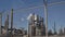 Industrial factory with smoke stacks protected by chain link fence