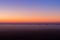 Industrial foggy landscape, silhouette of old factory against the sunset sky and the mist at blue hour at night