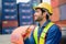 Industrial foreman working at overseas shipping container yard