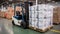 Industrial forklift stacker loader efficiently loading cardboard boxes in a spacious warehouse