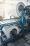 Industrial galvanized steel roll coil for metal sheet forming machine in metalwork factory workshop, vertical image