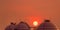 Industrial gas storage tank on orange sunset sky. LNG or liquefied natural gas storage tank. Spherical gas tank in petroleum