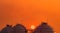 Industrial gas storage tank on orange sunset sky. LNG or liquefied natural gas storage tank. Spherical gas tank in petroleum