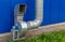 Industrial grade air extraction duct with electrical motor on blue wall