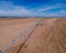 Industrial Grade Field Sprinkler in Fresh Dirt Field