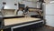 Industrial grade laser cutter working on plywood sheet - medium close