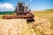 Industrial harvesting combine harvesting wheat