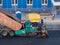 Industrial heavy road paver multifunctional modern, repair of road pavement in an urban environment, noisy work