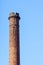 Industrial heritage, dangerously crumbled and cracked red brick chimney