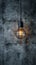 Industrial innovation hanging lightbulb on textured cement backdrop