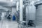Industrial interior of beverage factory, blue toned. Food and drink production manufacturing