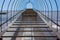 Industrial ladder on the facade of the building going up to the sky