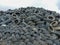 Industrial landfill for the processing of waste tires and rubber tyres. Pile of old tires and wheels for rubber recycling. Tyre