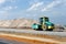 Industrial landscape with big roller compact gravel in speedway. Construction of a layers road amidst backdrop of gravel, crushed