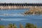 Industrial landscape. Powerful concrete dam blocks river