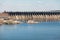 Industrial landscape. Powerful concrete dam blocks river