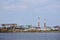 Industrial landscape, pulp and paper mill with stacks of logs on the river bank