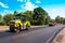 industrial landscape with rollers that rolls a new asphalt in the roadway. Repair, complicated transport movement