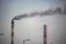 Industrial landscape - Smoke from the pipes of heat station with carry out harmful emissions.Petrochemical factory chimney.Its